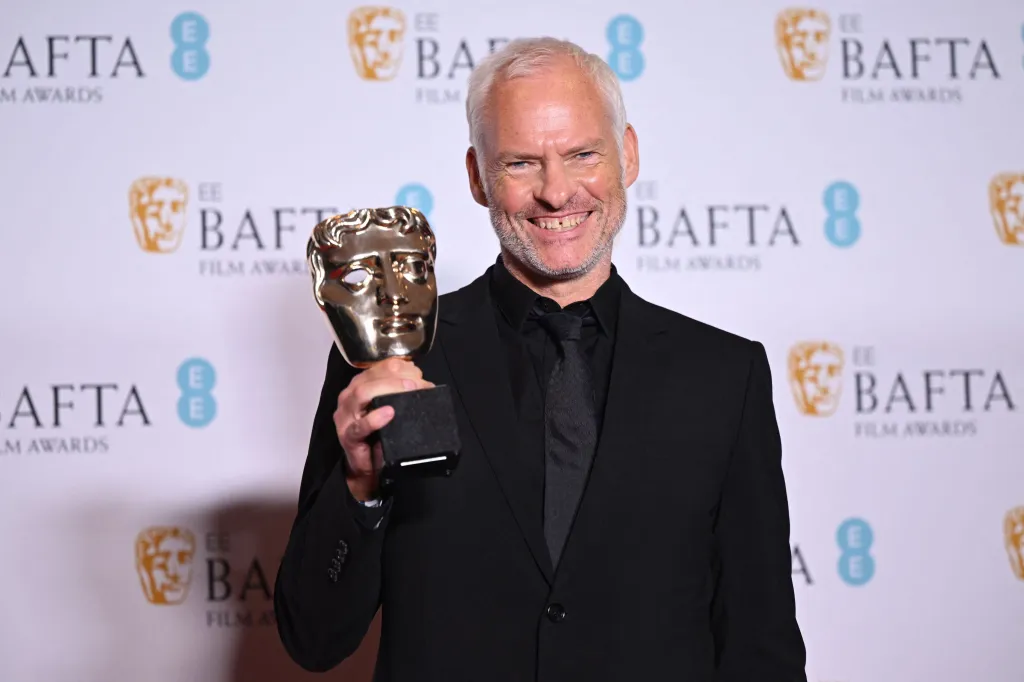 Martin McDonagh holding his Best Original Screenplay BAFTA award.
