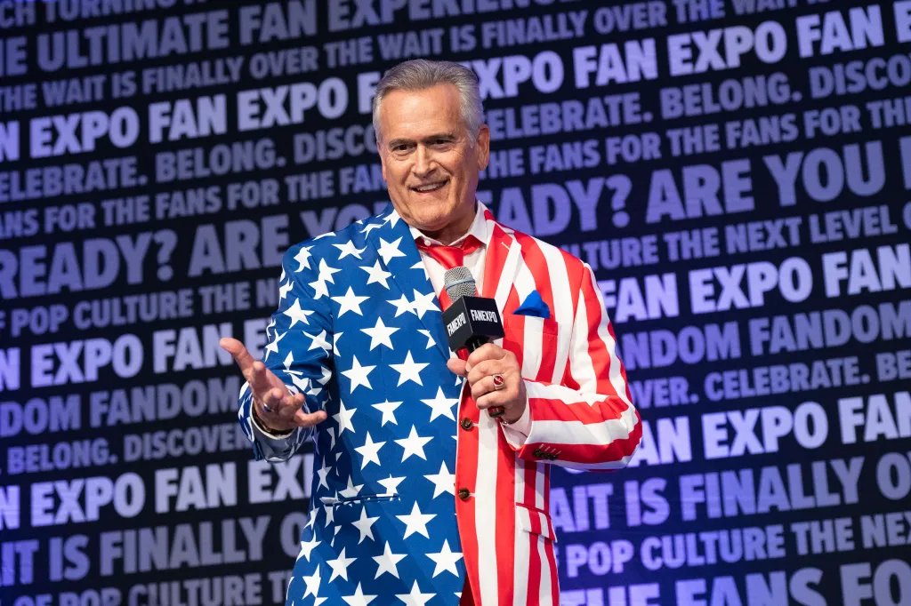 Bruce Campbell at the 2025 Fan Expo Denver, wearing an American flag-themed suit.