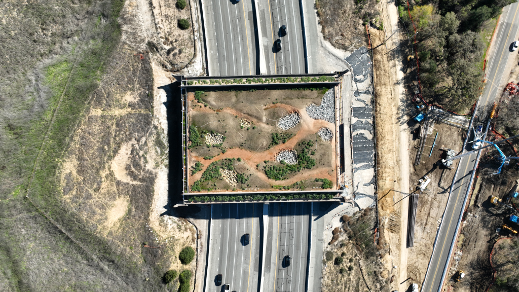 Aerial view of the Wallis Annenberg Wildlife Crossing over the 101 Freeway under construction.