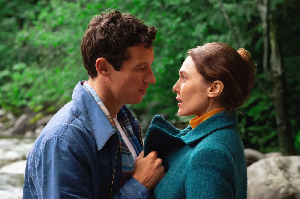 Elizabeth Olsen and Callum Turner looking at each other from the movie Eternity.
