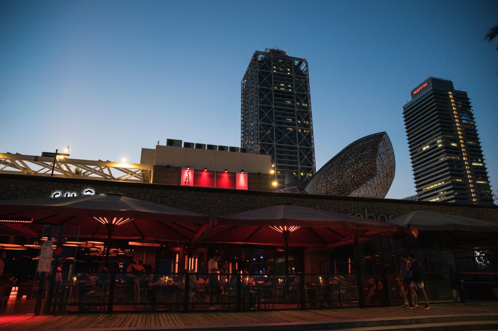 Nightclub in Barcelona, Spain with red lighting on its patio.