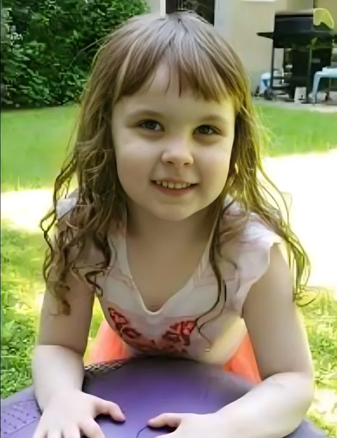 charlotte outside, smiling at the camera