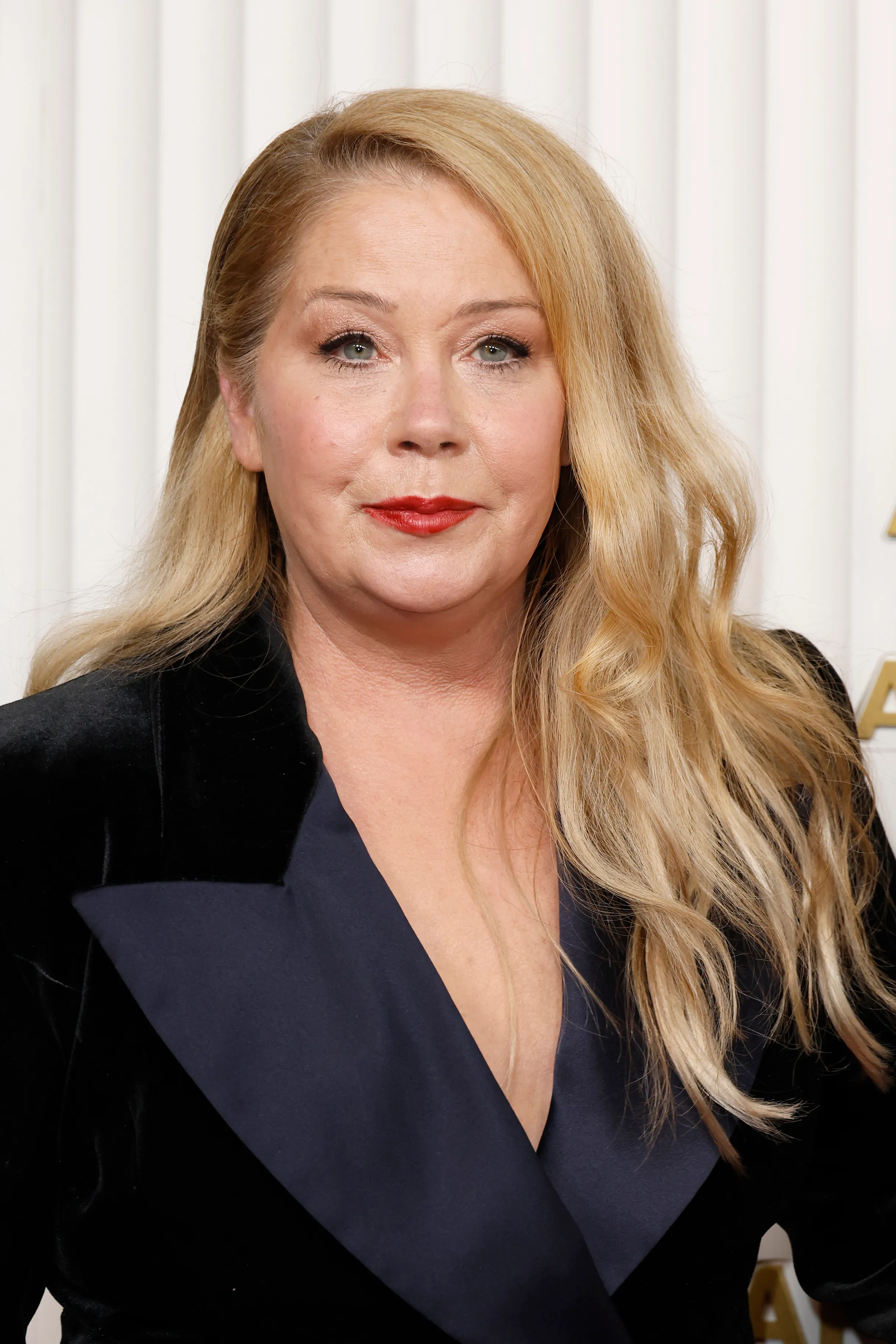 Christina Applegate in a black velvet blazer with dark blue lapels.