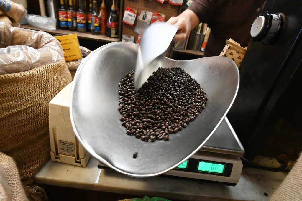Coffee beans being weighed on a scale at Porto Rico Importing Co.