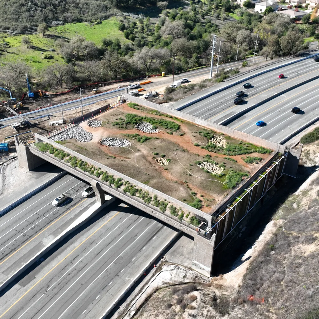 An aerial view of the Wallis Annenberg Wildlife Crossing under construction over the 101 Freeway in Agoura Hills, California.