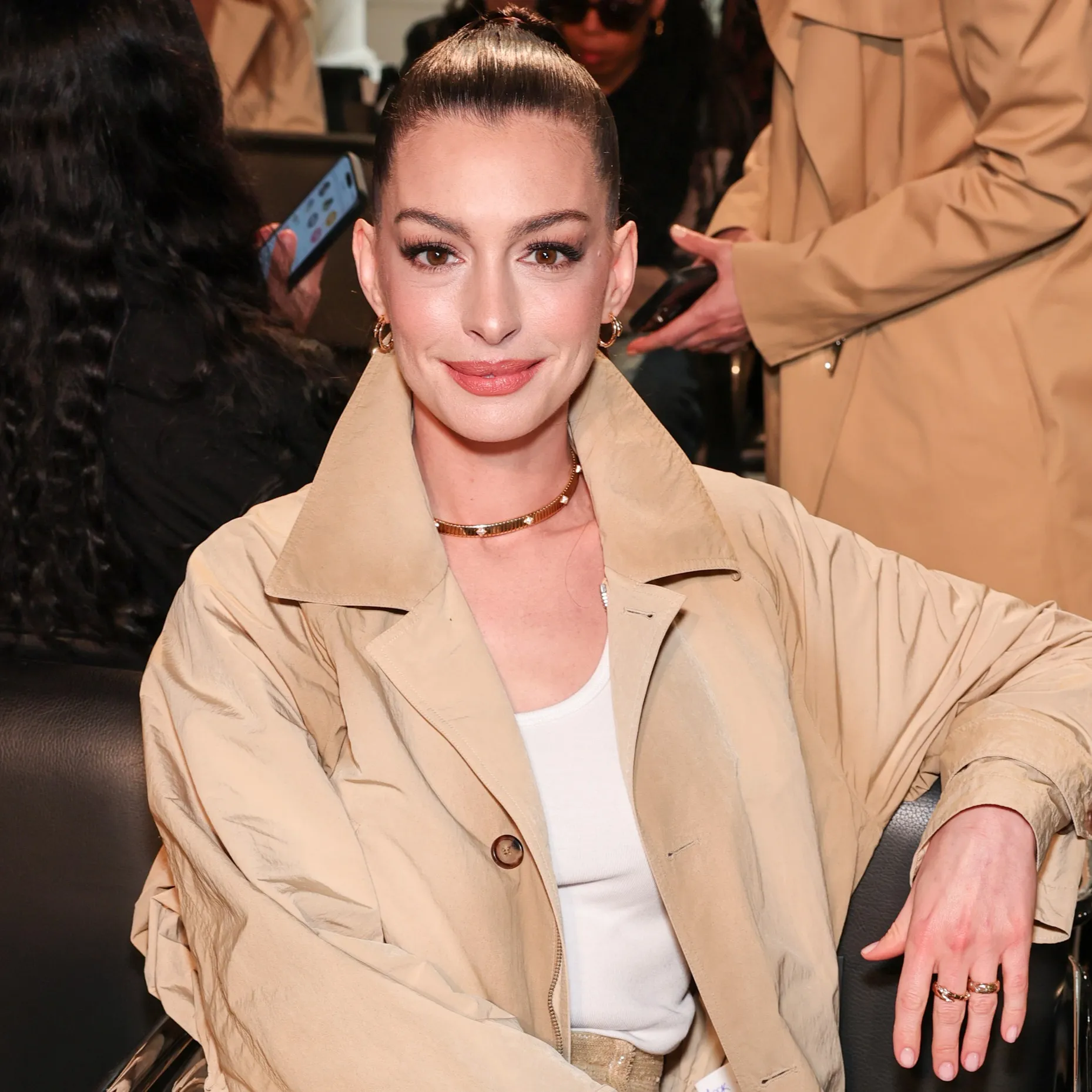 Hathaway in a trench coat.