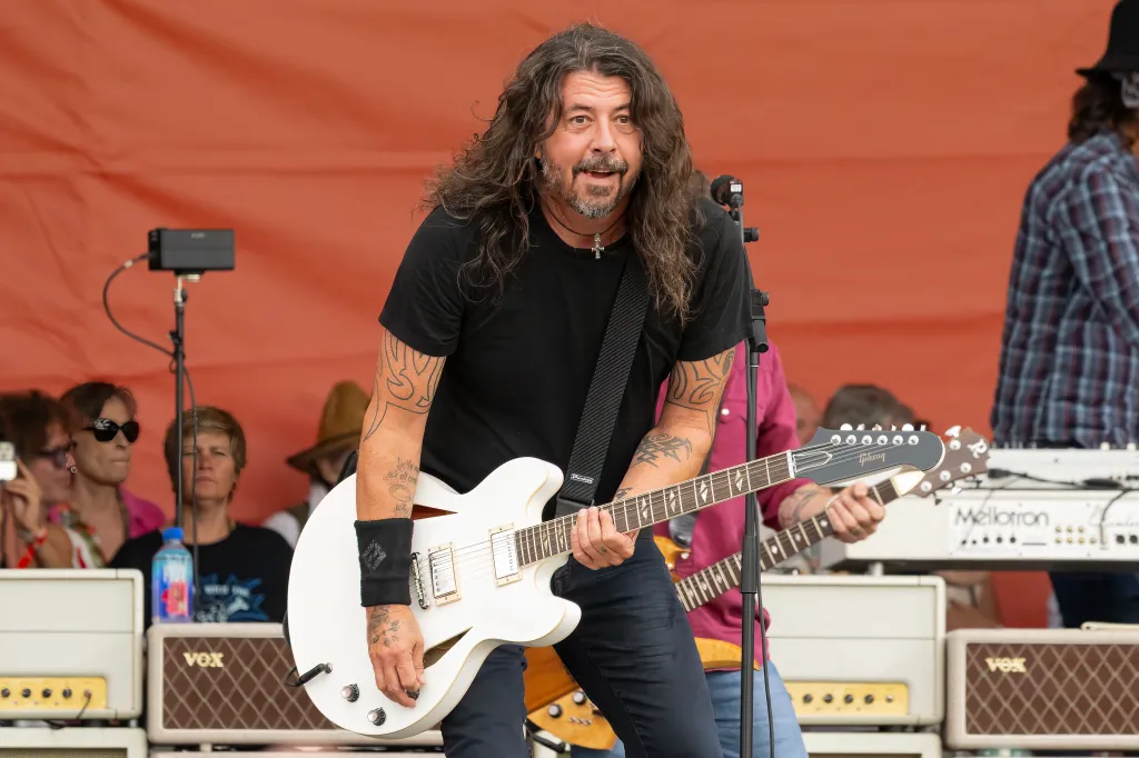Dave Grohl of Foo Fighters performing with a white electric guitar.