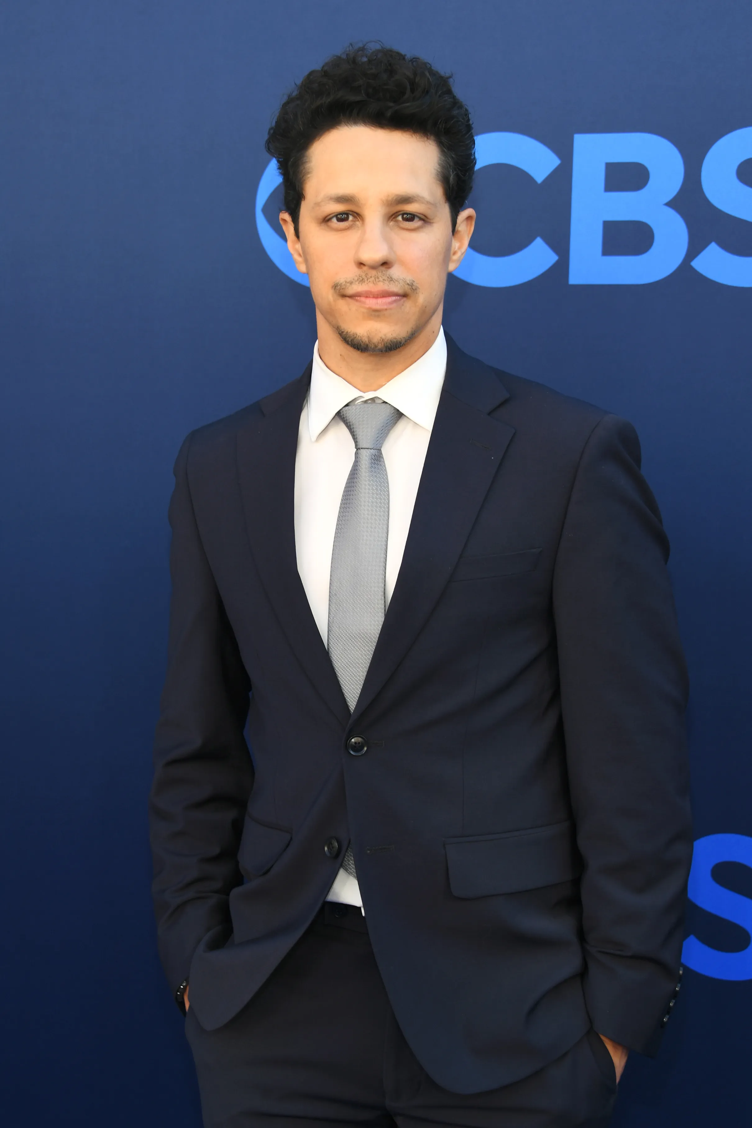 David Del Rio in a dark suit and light gray tie.