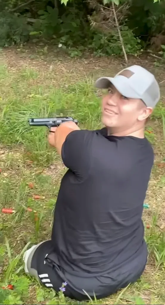 Dayton James Webber holds a gun in a YouTube video before he was arrested on murder charges.