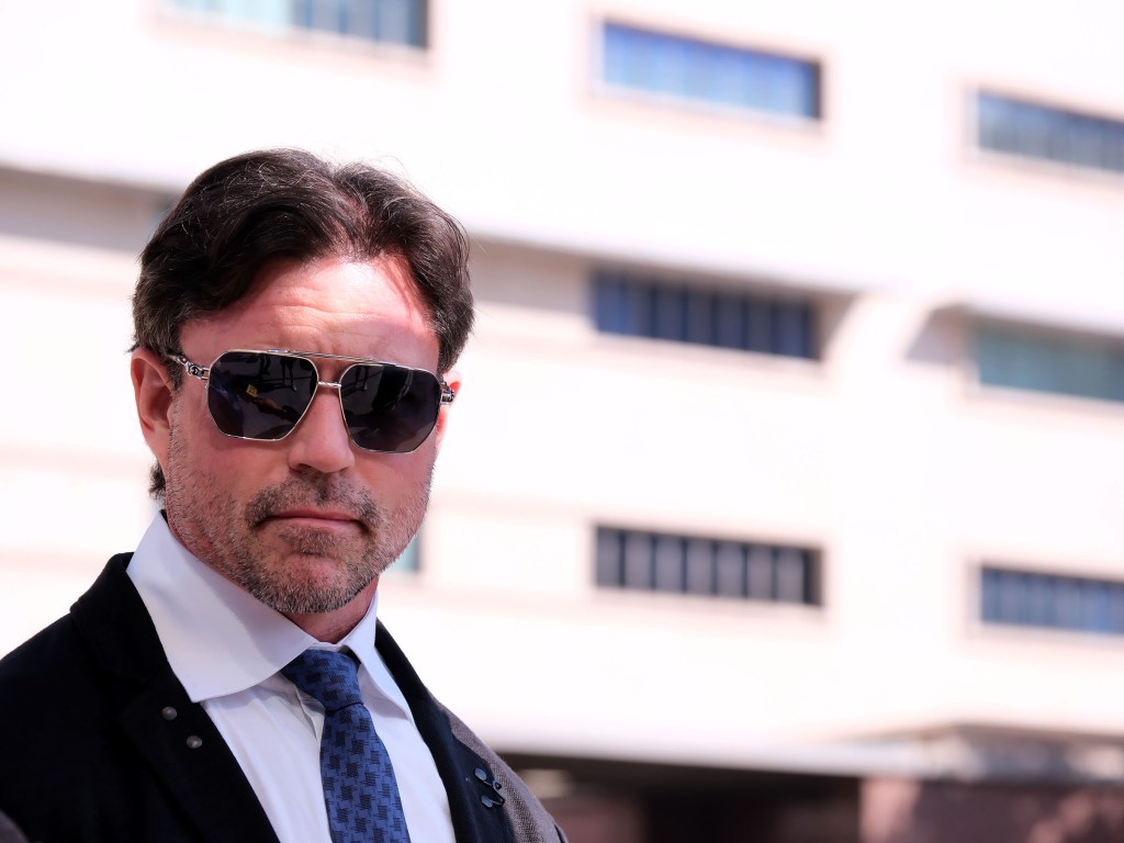 Aaron Phypers in sunglasses outside a courthouse.