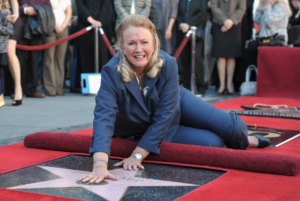 Diane Ladd placing her hands on her Walk of Fame star at the Hollywood Walk of Fame ceremony.