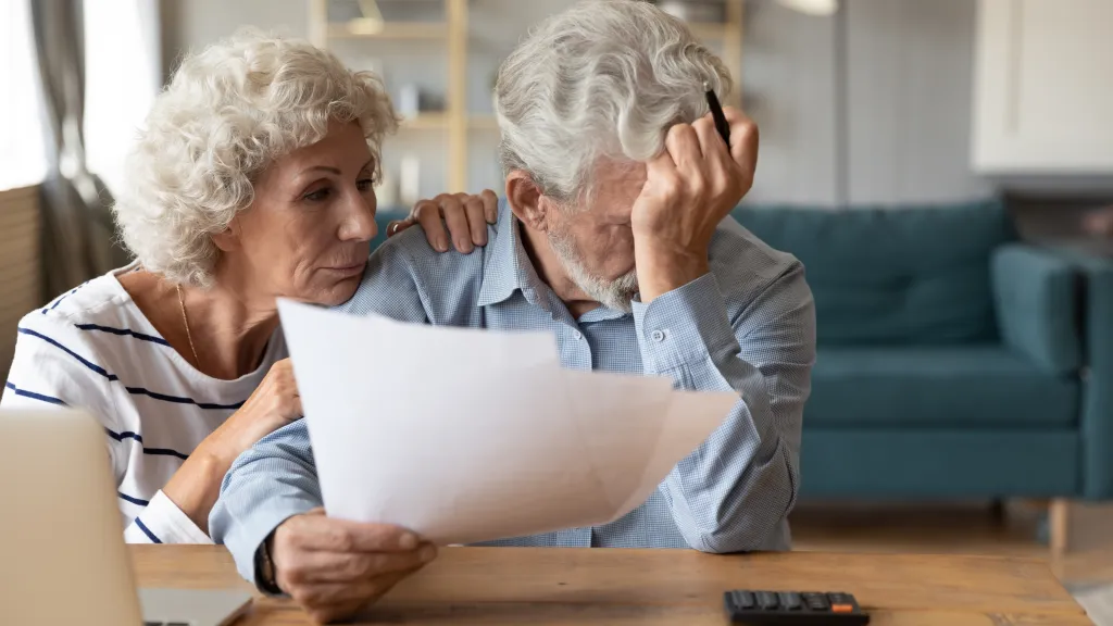 Elderly couple distressed by household finances.