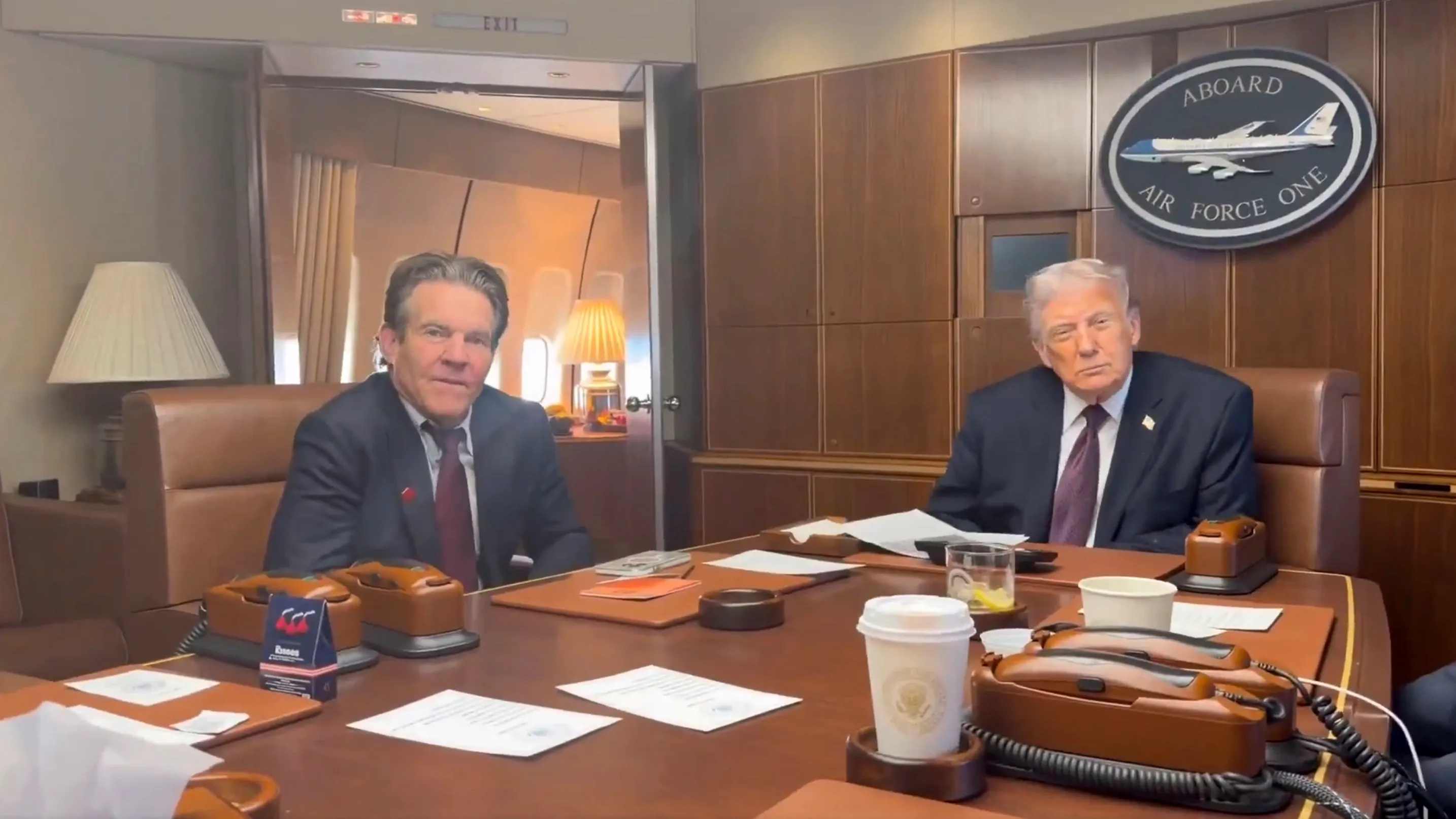 Dennis Quaid sits next to President Donald Trump during a flight aboard Air Force One on Feb. 27, 2026.