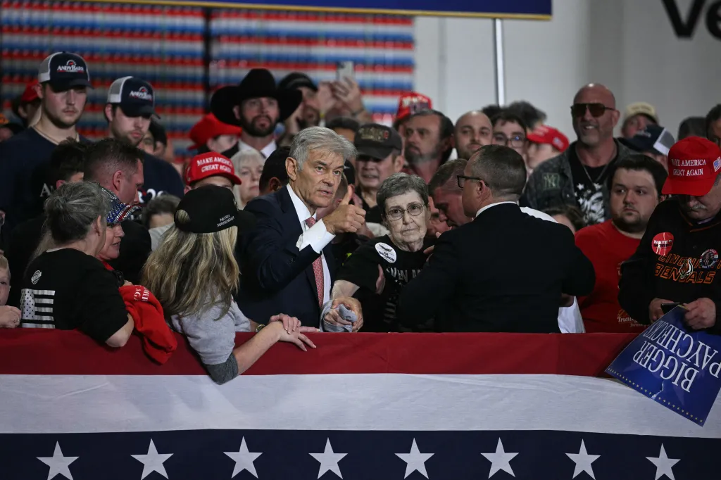 Dr. Mehmet Oz, Centers for Medicare and Medicaid Services administrator, gave a thumbs up after helping a woman who fainted while President Donald Trump spoke at Verst Logistics in Hebron, Kentucky, on March 11. (