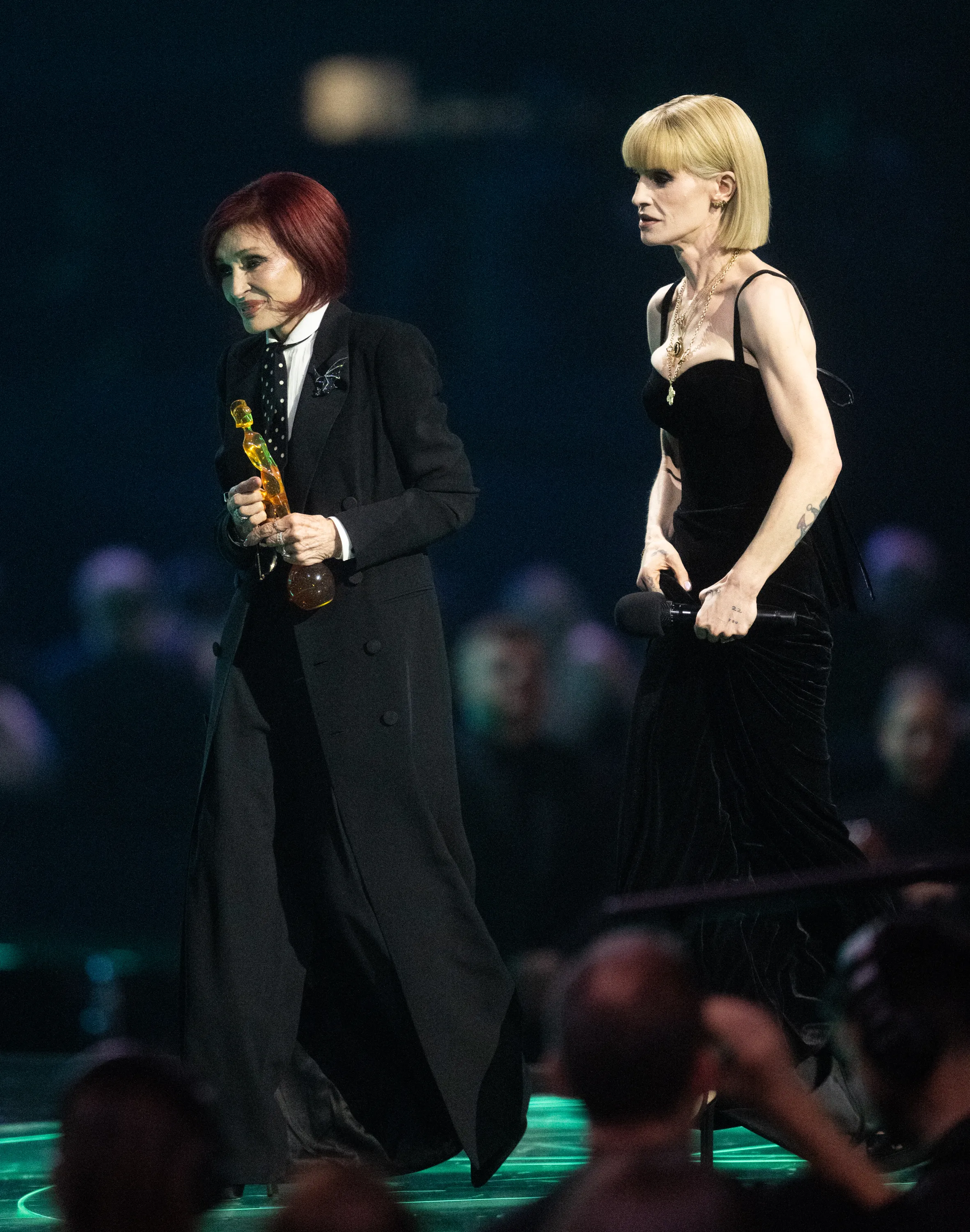 Kelly and Sharon Osbourne on stage accepting the Lifetime Achievement Award.
