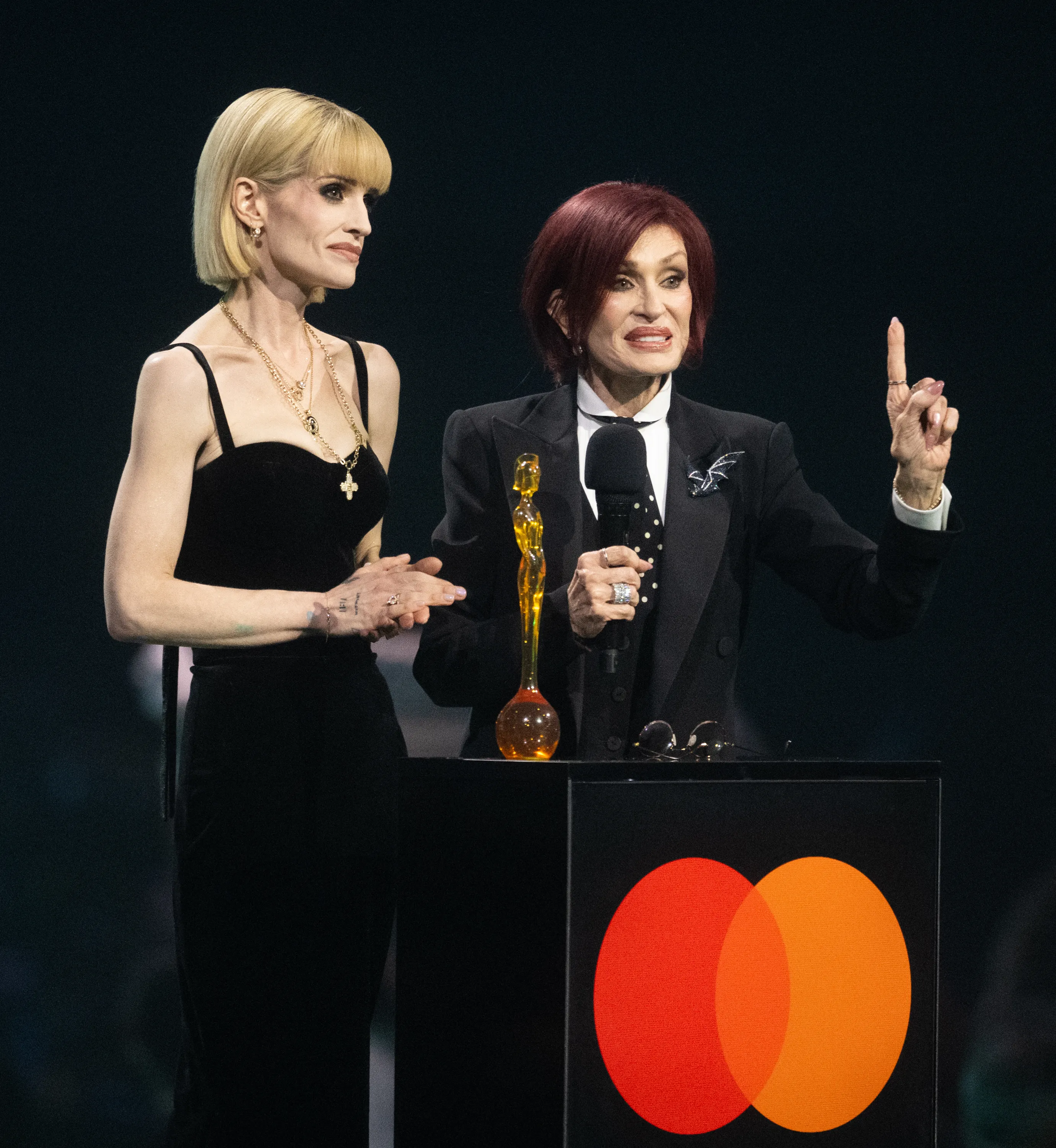 Kelly Osbourne and Sharon Osbourne accept the Lifetime Achievement Award for Ozzy Osbourne at the BRIT Awards.