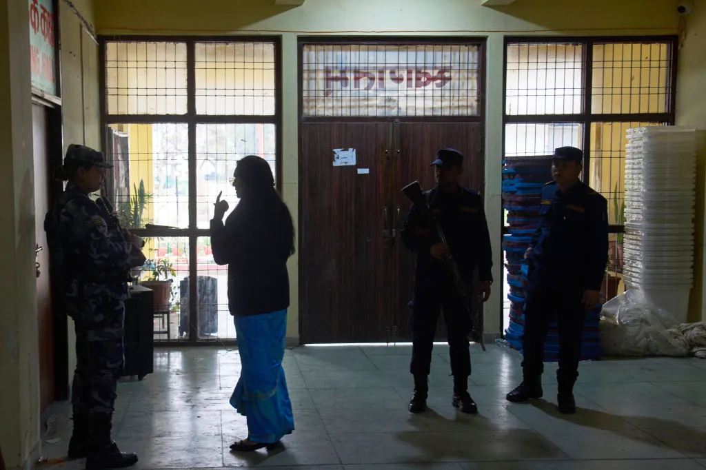 An Election Officer speaks to a police officer at a counting center in Lalitpur, Nepal.