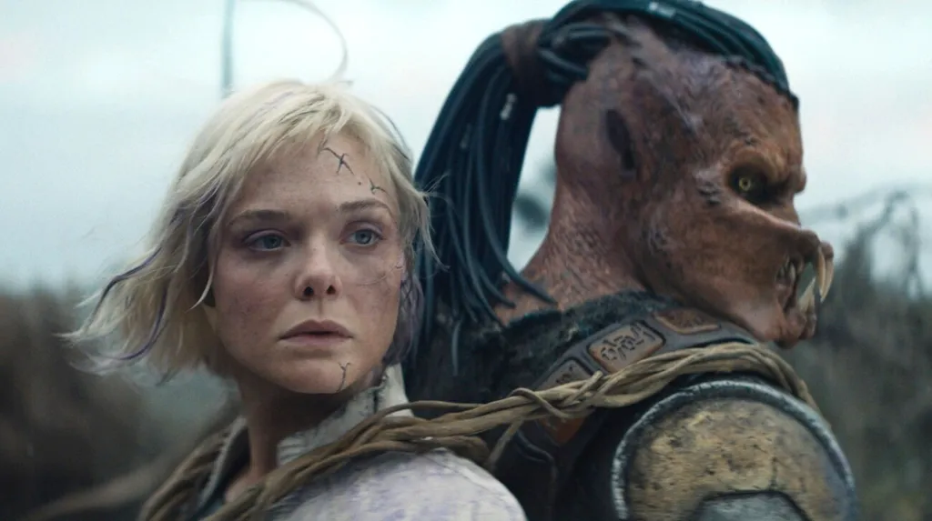 Ella Fanning and a Predator from the film Predator: Badlands.