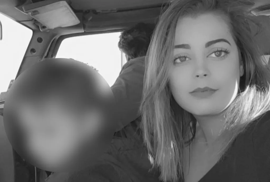 Emily Panuco, with her child blurred in the background, in a car.