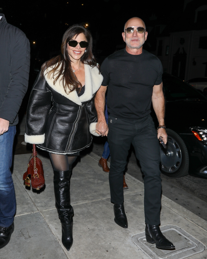 Jeff Bezos and Lauren Sanchez holding hands and walking in Los Angeles.