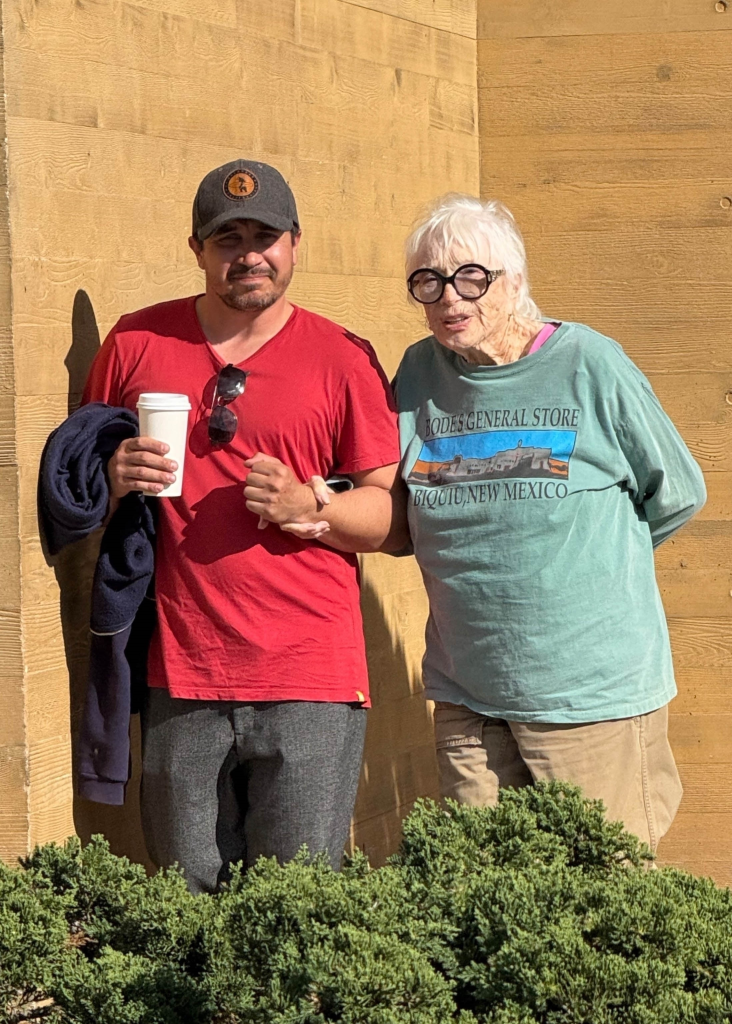 Shirley MacLaine being assisted by a man after lunch.