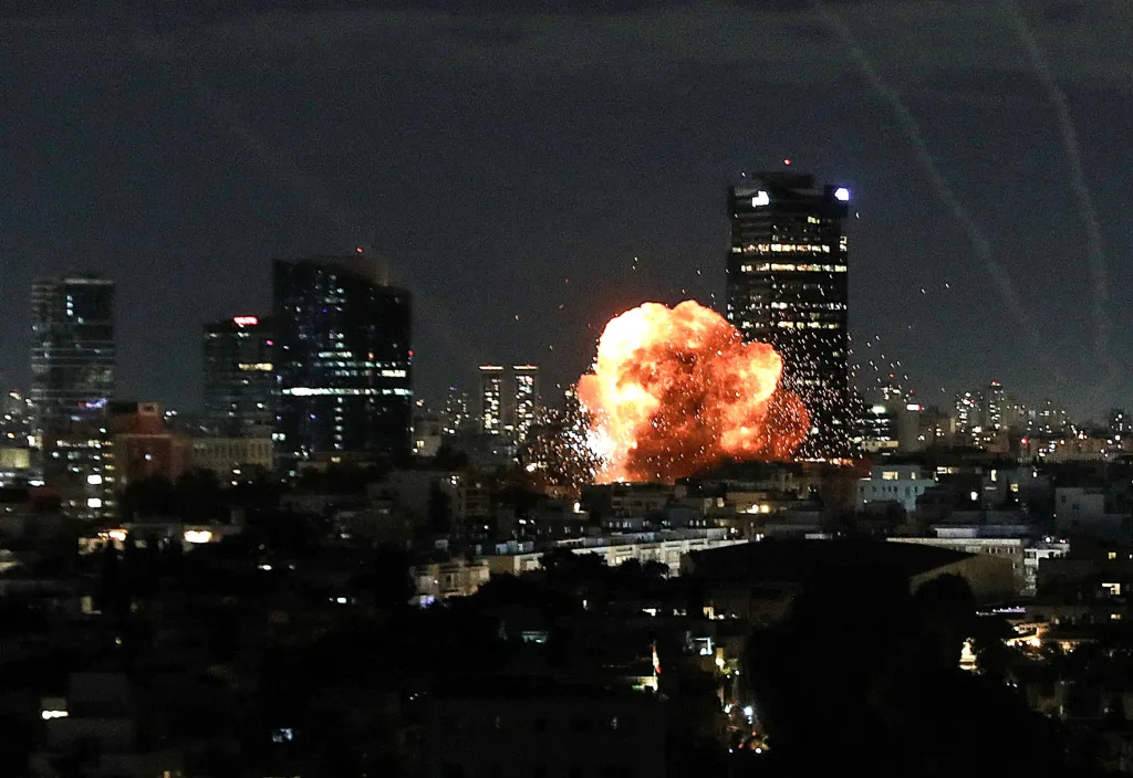 An explosion in the sky above a city skyline at night.