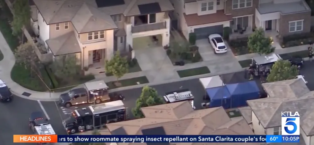 Aerial view of hazmat vehicles and personnel outside suburban homes.