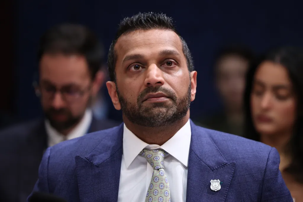 Kash Patel, wearing a blue suit and patterned tie, listens during a House Permanent Select Committee on Intelligence hearing.