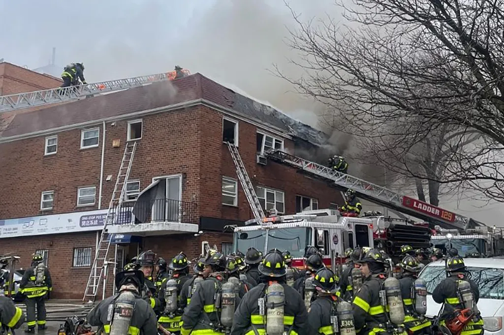 Firefighters extinguishing a building fire in Queens, New York.