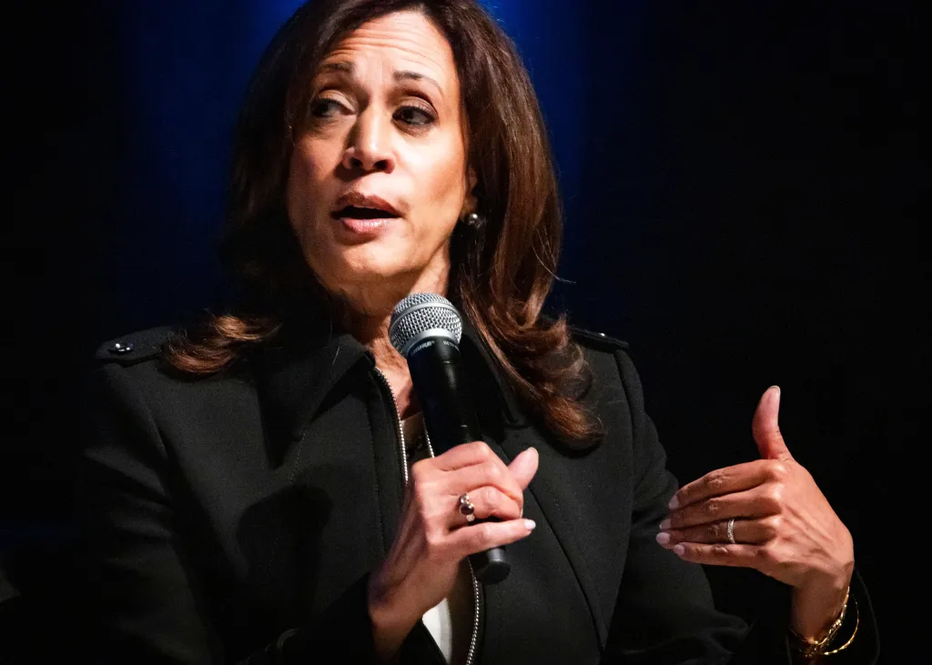 Kamala Harris speaking into a microphone.