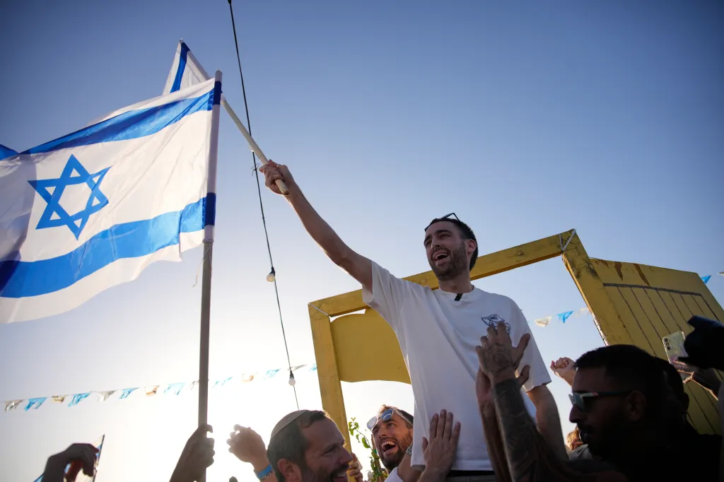 Or stands next to an Israeli flag after his release. 