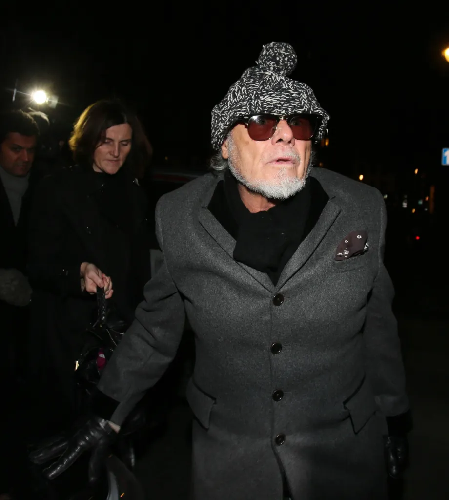 Gary Glitter arrives home after a day at the police station in London.