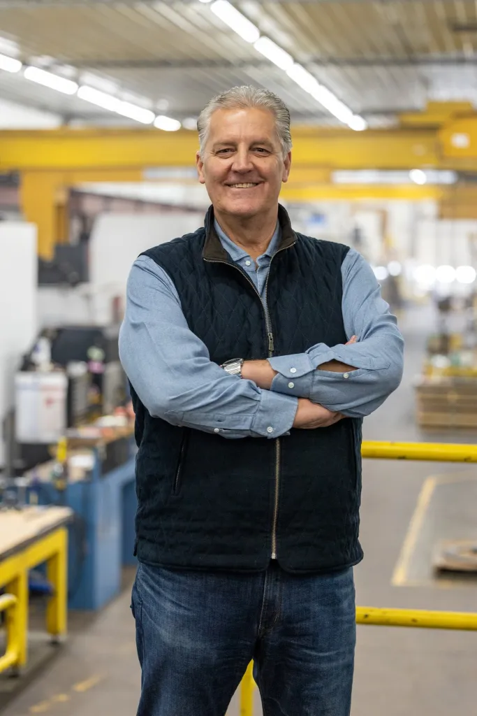 Kevin Hermening, GOP House candidate from Wisconsin, standing in a factory.