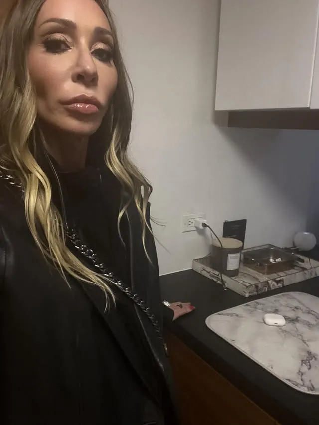 Hailey Glassman poses for a selfie, wearing a black blazer.