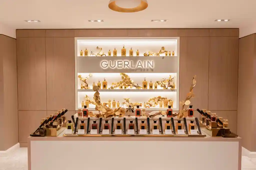 Guerlain perfume display with gold decorative elements.