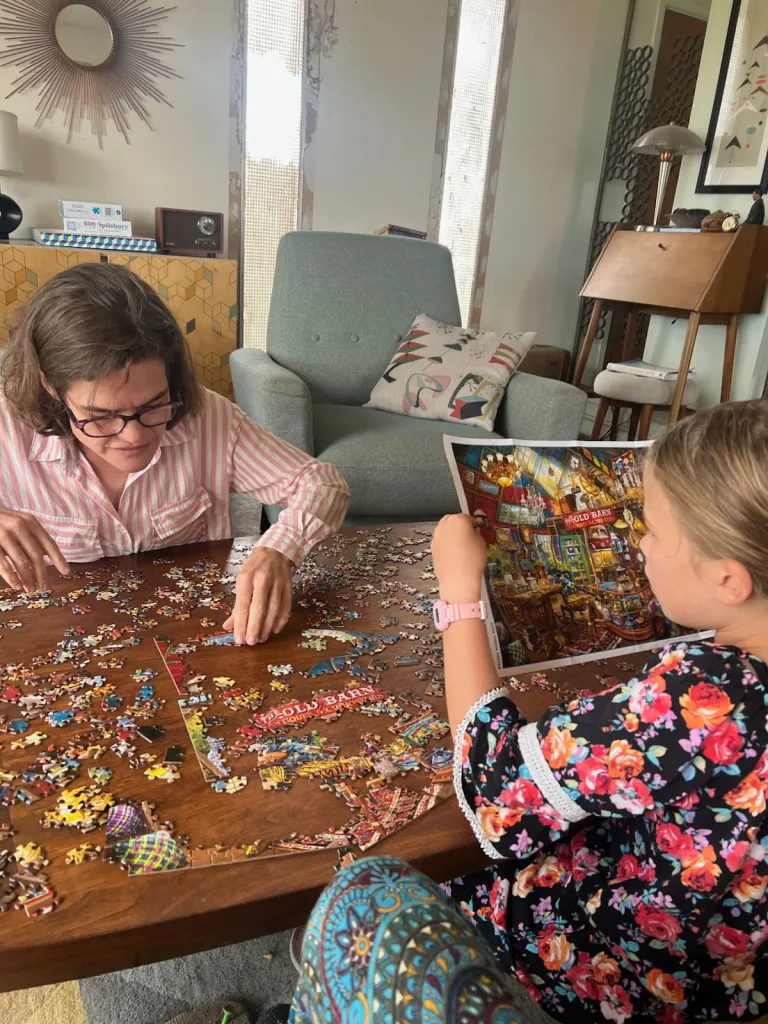 Michaeleen Doucleff and her daughter Rosy working on a puzzle together.