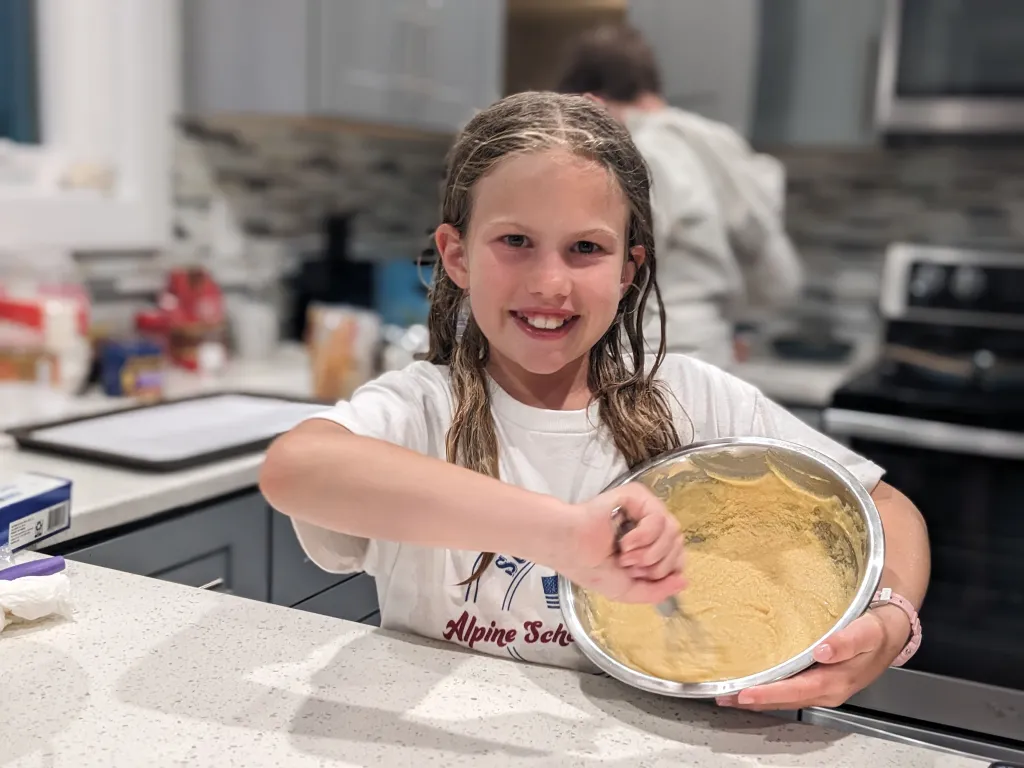 Rosy baking in a kitchen, mixing batter in a bowl.