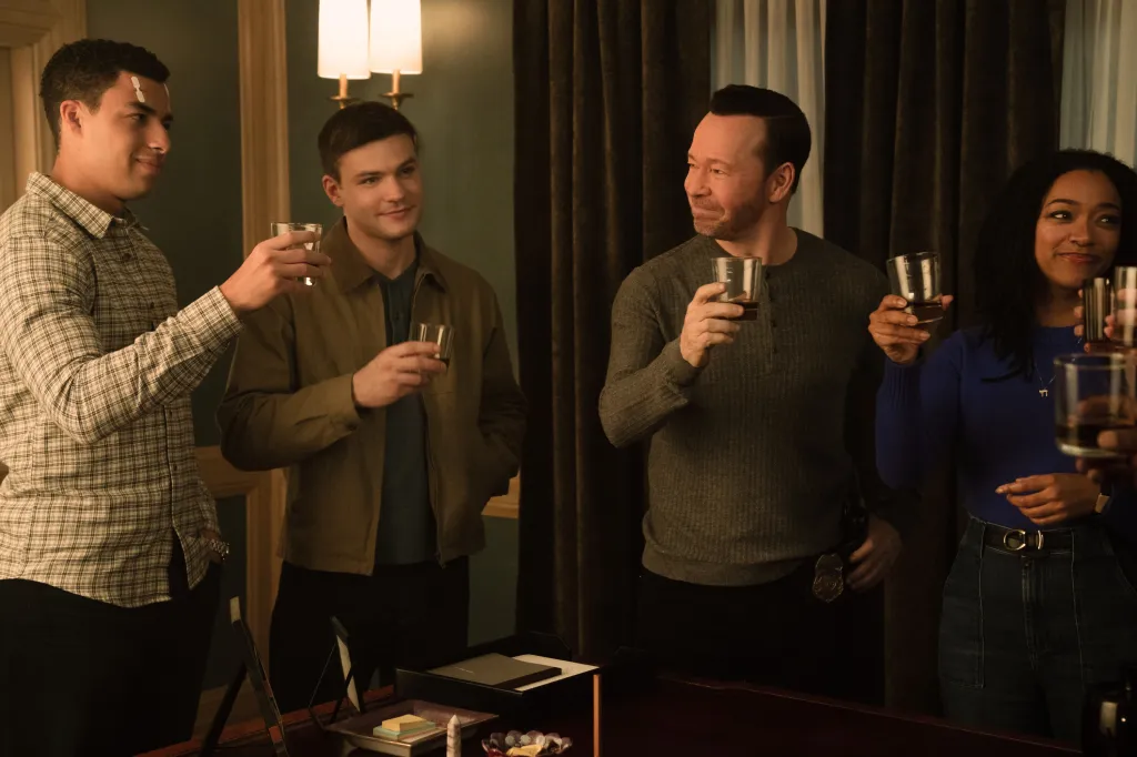 Marcus Scribner as Jonah Silver, Mika Amonsen as Sean Reagan, Donnie Wahlberg as Danny Reagan, and Sonequa Martin-Green as Lena Silver toasting with drinks.