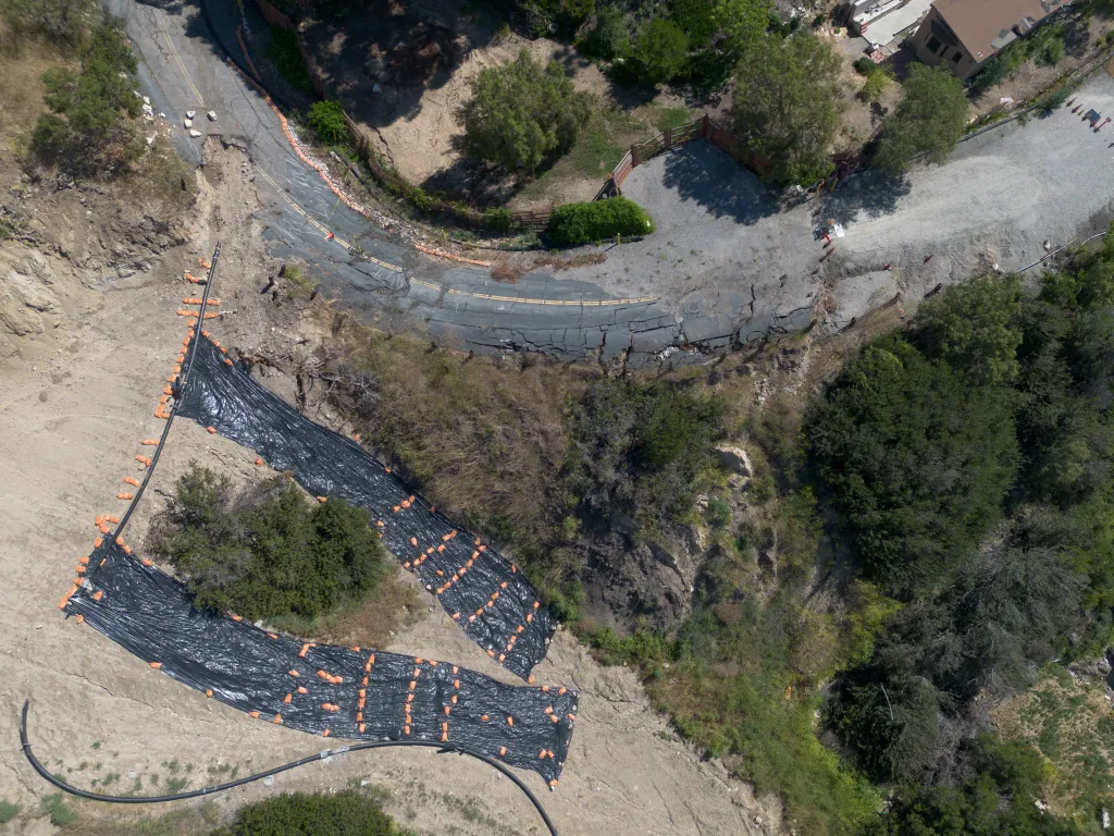 Aerial view of Narcissa Drive in Rancho Palos Verdes, CA, heavily damaged by landslides.