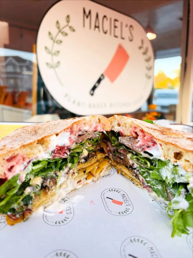 Post-Thanksgiving sandwich from Maciel's Plant-Based Butcher & Deli with herb-turkey, sautéed mushrooms, melted gouda, cranberries, arugula, and mayo on ciabatta.