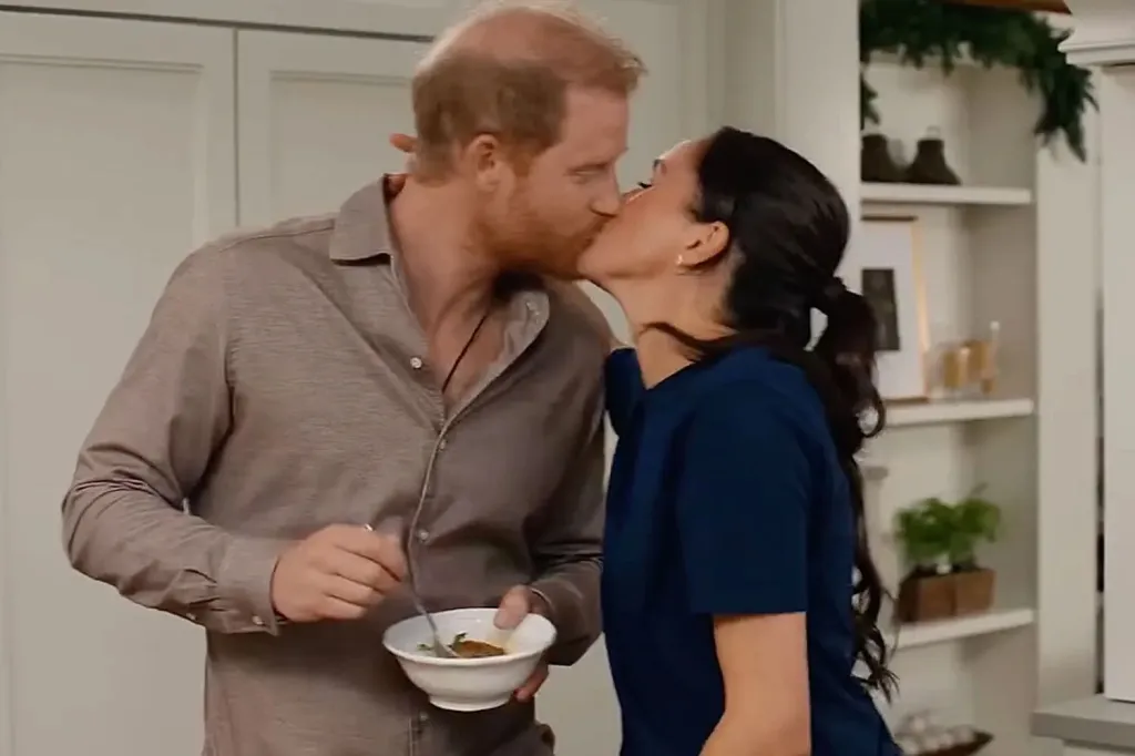 Prince Harry, in a brown shirt, and Meghan Markle , in a blue dress, kissing while he holds a bowl.