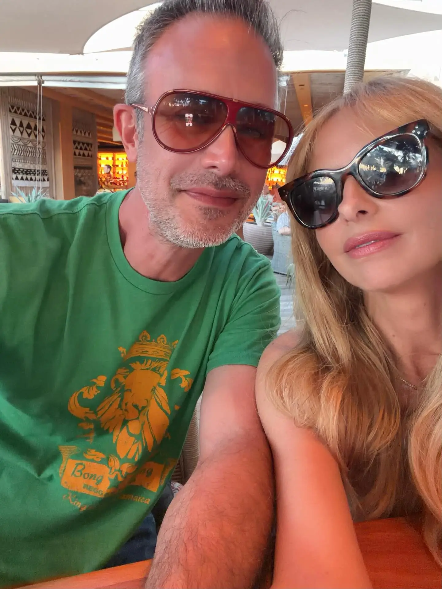 Sarah Michelle Gellar and Freddie Prinze Jr. pose in sunglasses for a selfie.