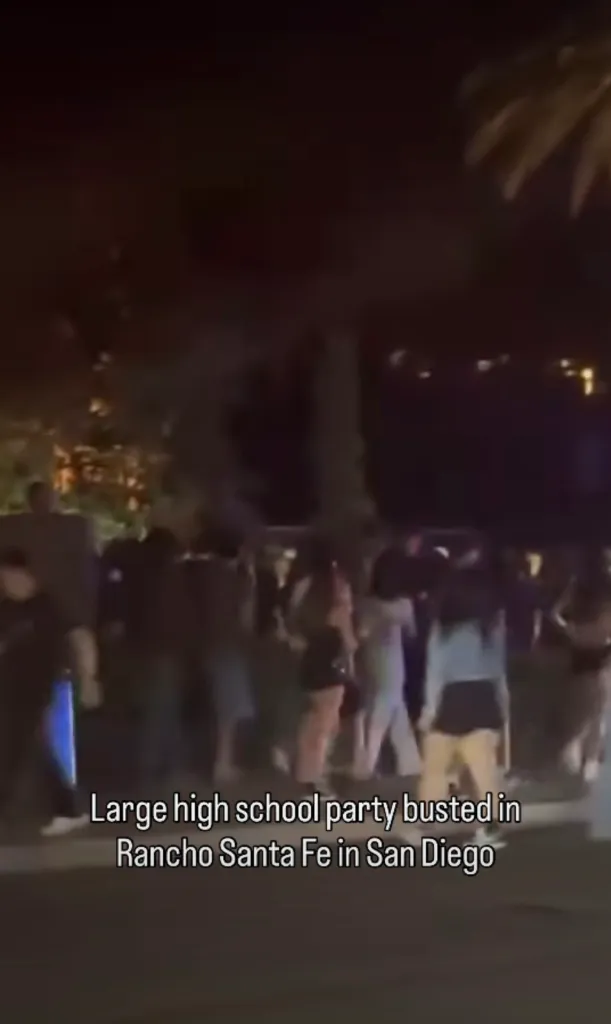 Nighttime photo of a large crowd gathered on a street in Rancho Santa Fe, San Diego.