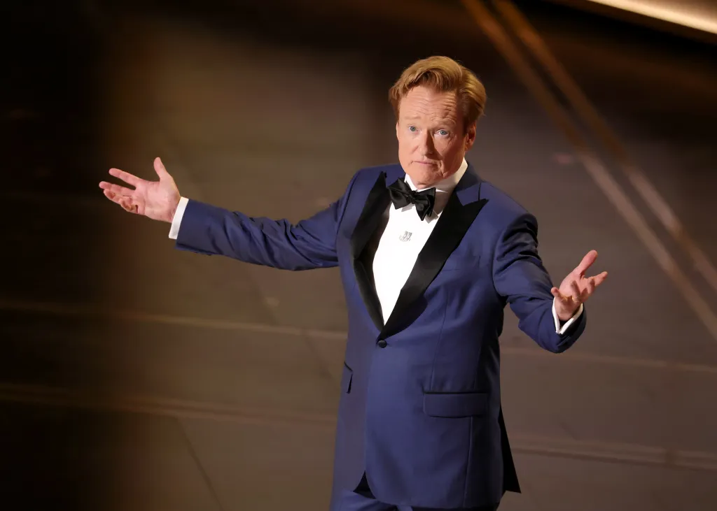 Conan O'Brien speaking onstage at the 98th Oscars.