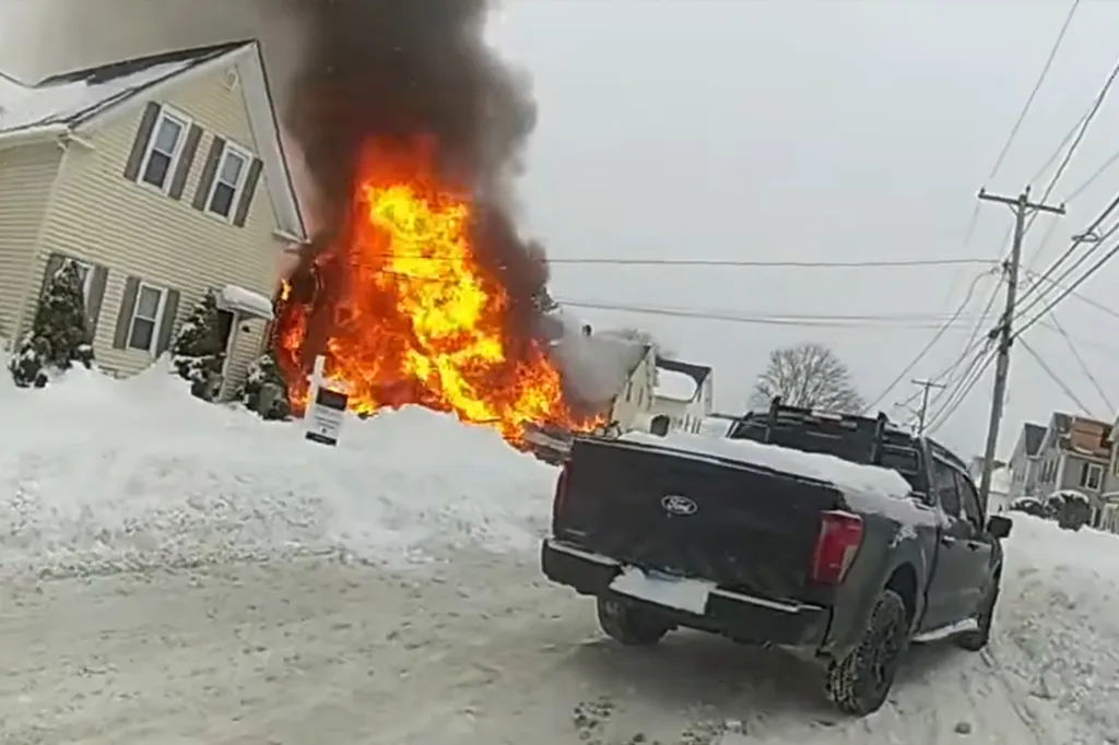 A house engulfed in flames after a natural gas leak explosion in Taunton, Massachusetts.