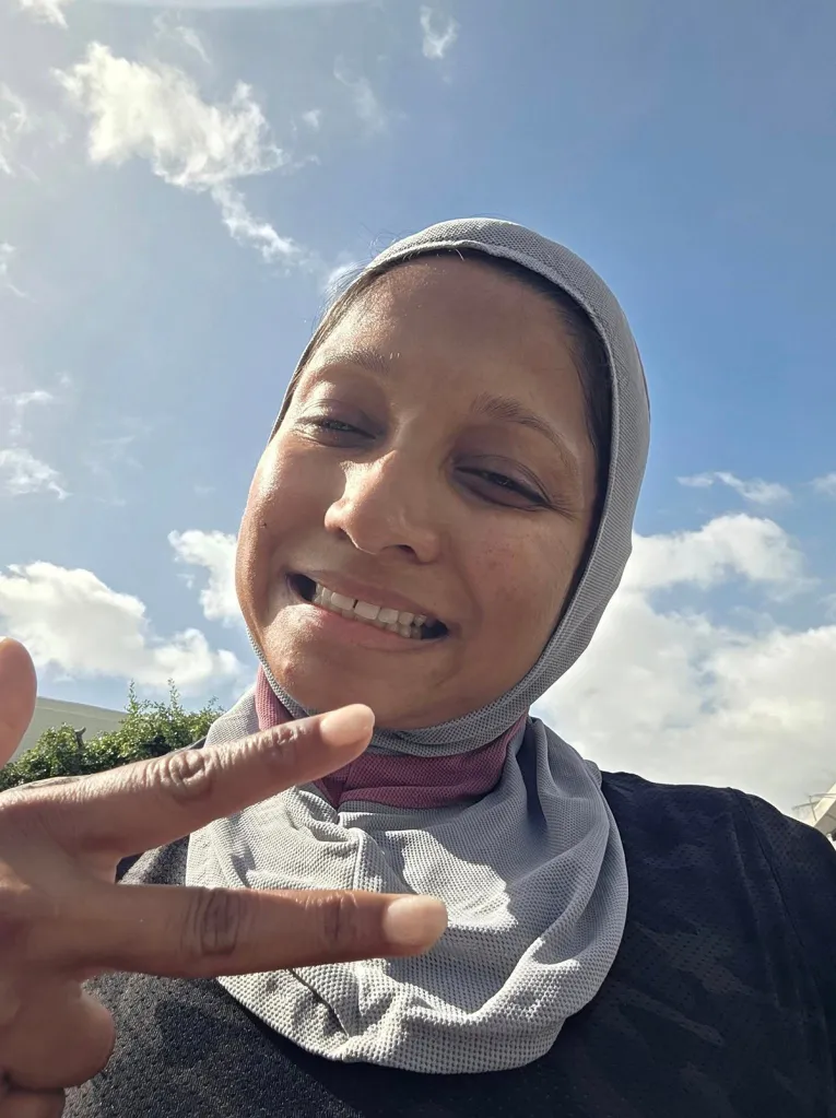 Fatima Iqbal-Zubair smiling and making a peace sign.