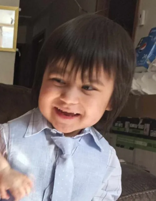 Tristan Stately smiling while wearing a light blue dress shirt and polka dot tie.