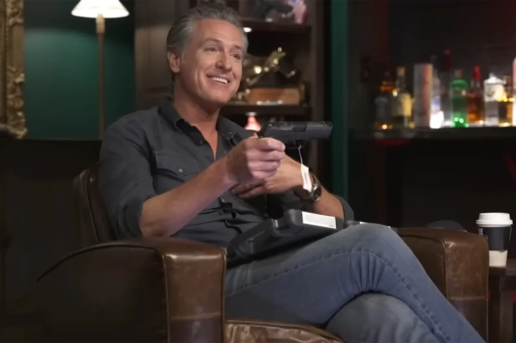 Gavin Newsom holding a pistol.