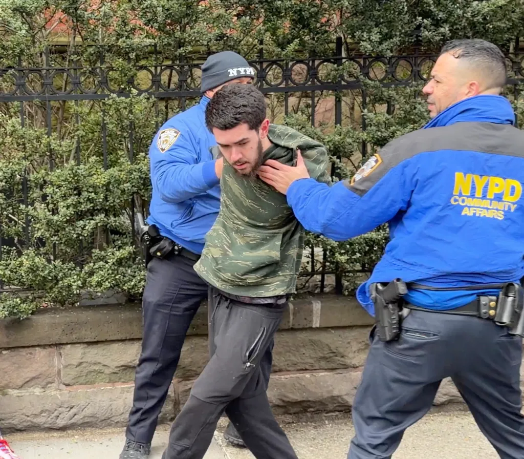 Ibrahim Kayumi is arrested after two homemade explosive devices were tossed outside Gracie Mansion Saturday during competing anti- and pro-Muslim protests, causing a panic.
