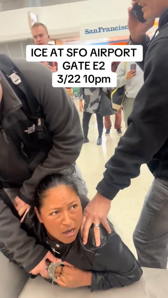 ICE officers detaining and handcuffing a woman at San Francisco International Airport.